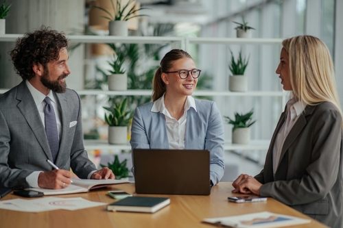 Three business leaders collaborating with a virtual CFO Services team online to review financial performance and planning.
