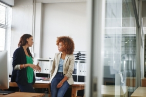cfo services toronto consultation between two business leaders reviewing financial strategy in a modern office environment.