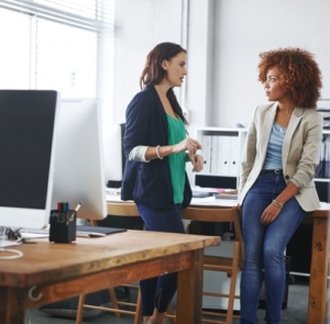 cfo services toronto advisor meeting with client to discuss cash flow and growth planning in a bright office while reviewing documents.