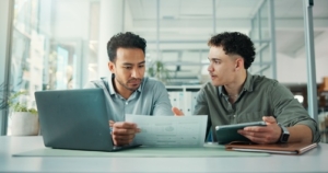 Fractional CFO services Toronto financial consultant discussing financial statements and cash flow planning with business owner in office meeting