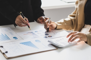 Business leaders reviewing financial reports with S.A. Associates while evaluating whether to recruit a CFO in Toronto or use fractional CFO services.