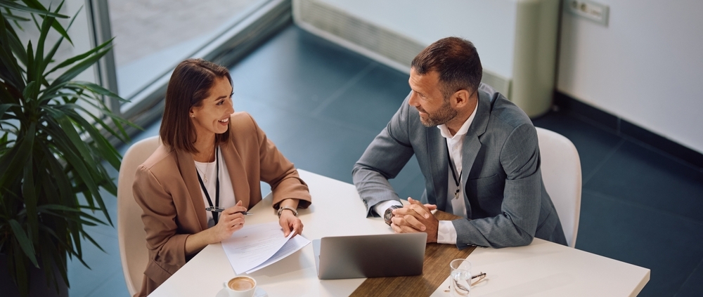 Business owner researching how much does a fractional CFO cost while reviewing financial reports in a Guelph Ontario office