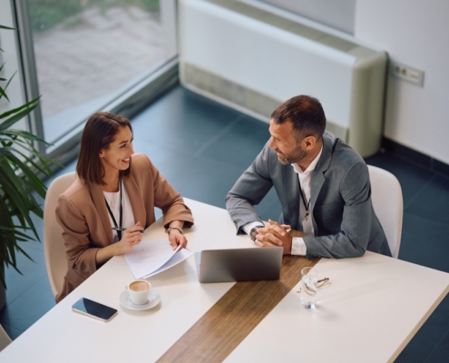 Business owner researching how much does a fractional CFO cost while reviewing financial reports in a Guelph Ontario office