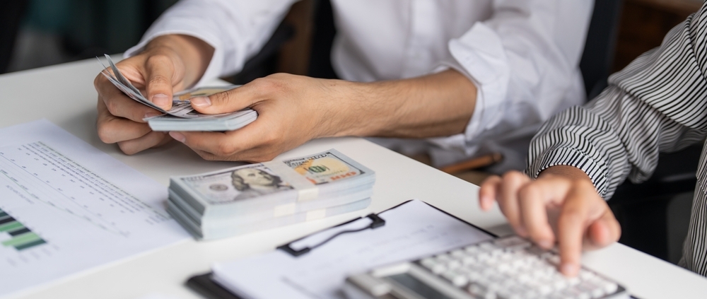 Business owner learning how to improve cash flow management while reviewing financial statements in a Guelph Ontario office