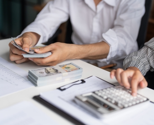 Business owner learning how to improve cash flow management while reviewing financial statements in a Guelph Ontario office
