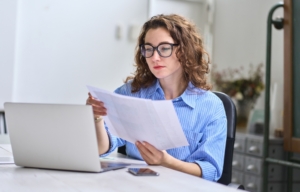 Business owner learning how to improve business profitability while reviewing financial reports with a fractional CFO in Guelph Ontario