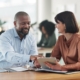 Growing business owner reviewing financial statements for bank loans with a fractional CFO advisor in Guelph Ontario
