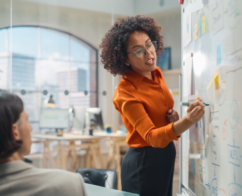 Business owner facing the challenges of scaling a business while reviewing financial reports with a fractional CFO advisor in Guelph Ontario